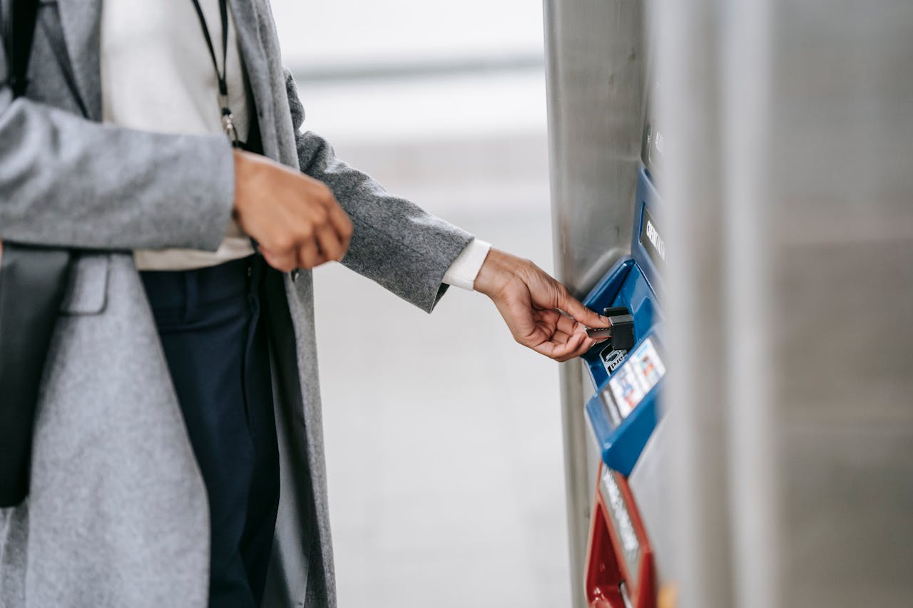 Crafting Captivating Headlines: Your awesome post title goes here A woman in formal wear using a subway ticket machine, representing urban commuting.